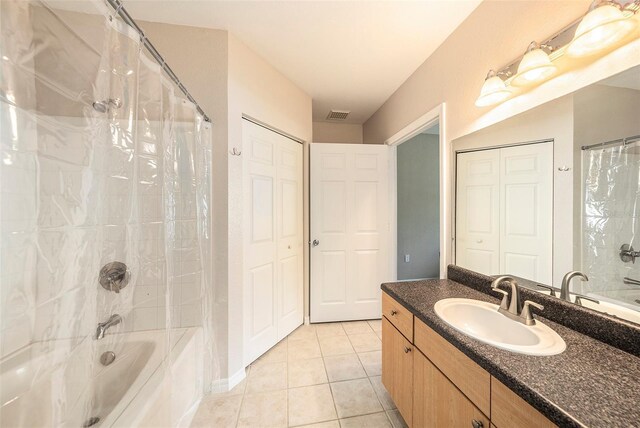 bathroom with tile patterned flooring, shower / bathtub combination with curtain, and vanity