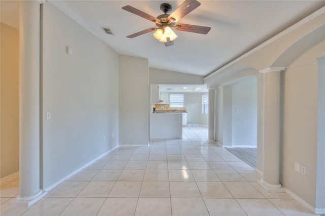 interior space with lofted ceiling, ceiling fan, light tile patterned floors, and decorative columns