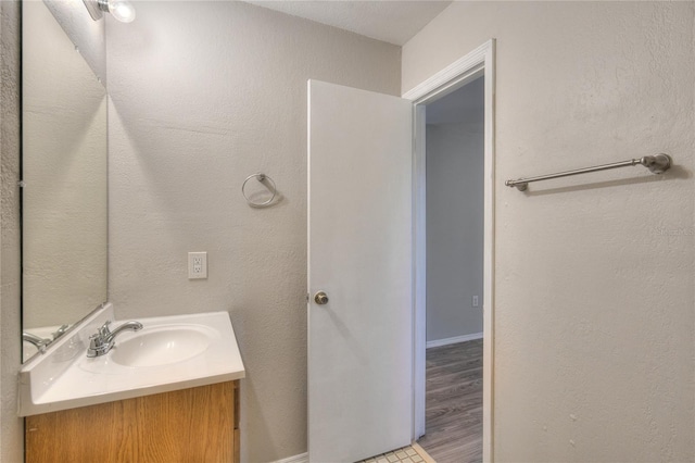 bathroom with hardwood / wood-style flooring and vanity