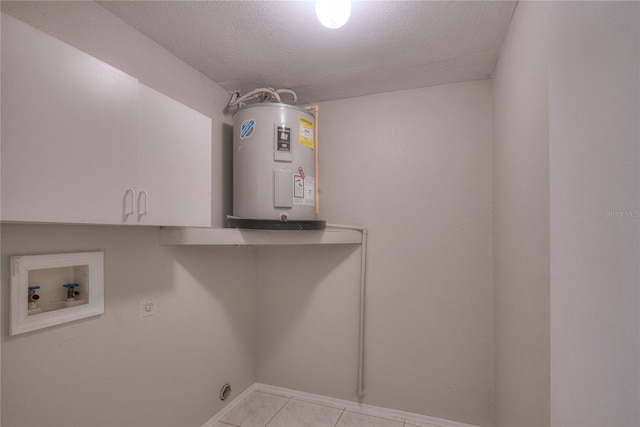 washroom featuring hookup for a washing machine, water heater, hookup for an electric dryer, cabinets, and a textured ceiling