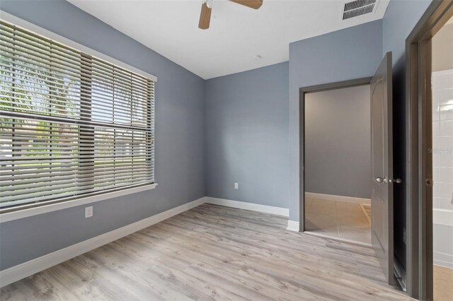 unfurnished room with ceiling fan and light hardwood / wood-style flooring