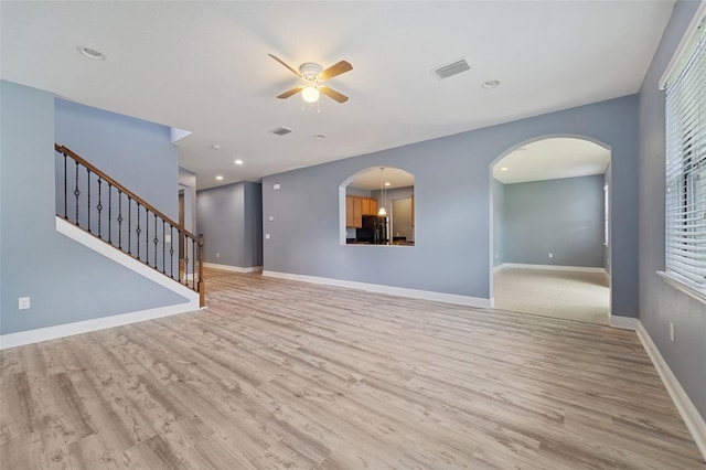 unfurnished living room with hardwood / wood-style floors and ceiling fan