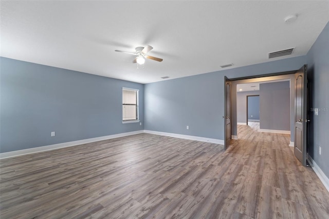 empty room featuring ceiling fan and wood-type flooring