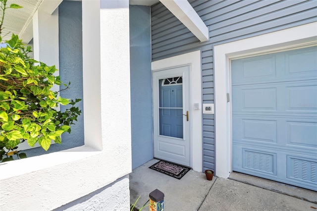 view of exterior entry featuring a garage