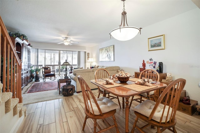 dining area with ceiling fan and light wood-type flooring