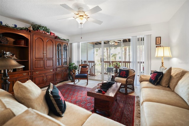 living room featuring a textured ceiling and ceiling fan