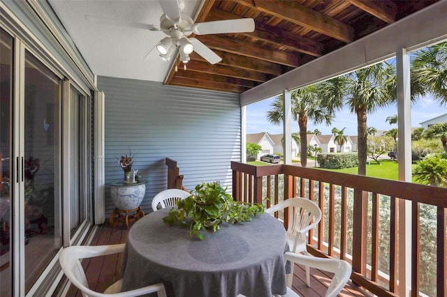 sunroom / solarium with a wealth of natural light, ceiling fan, beam ceiling, and wood ceiling