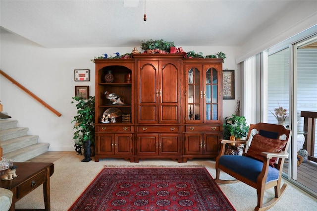 sitting room featuring light colored carpet