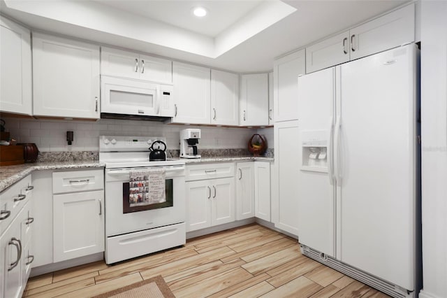 kitchen featuring light wood-type flooring, white appliances, backsplash, and white cabinets