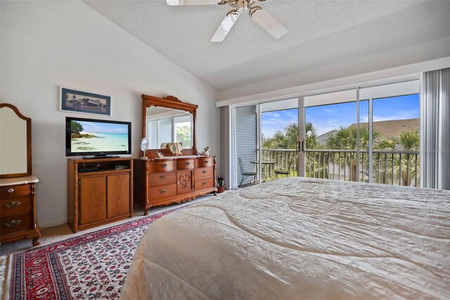 bedroom with carpet flooring, lofted ceiling, access to exterior, ceiling fan, and a textured ceiling