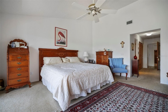 carpeted bedroom with vaulted ceiling and ceiling fan