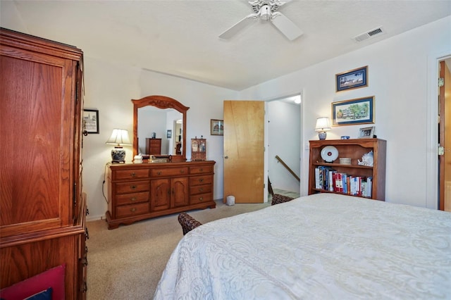 bedroom with ceiling fan and light carpet