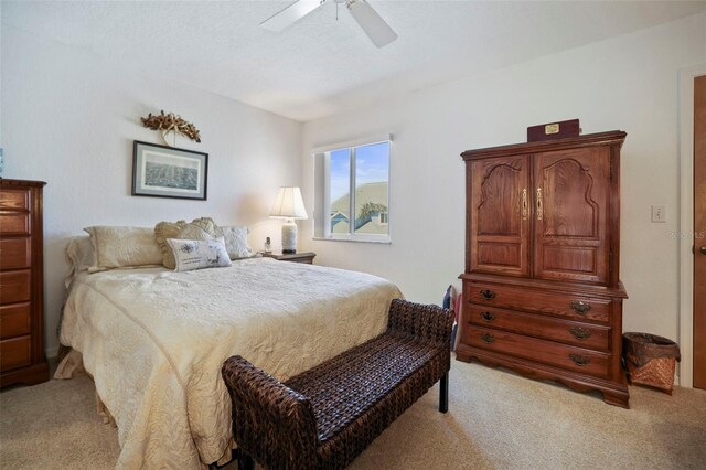 bedroom featuring light colored carpet and ceiling fan