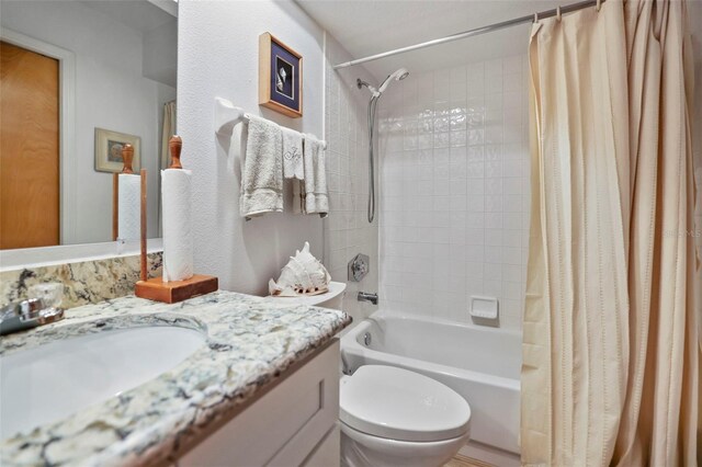 full bathroom featuring vanity, toilet, and shower / bathtub combination with curtain