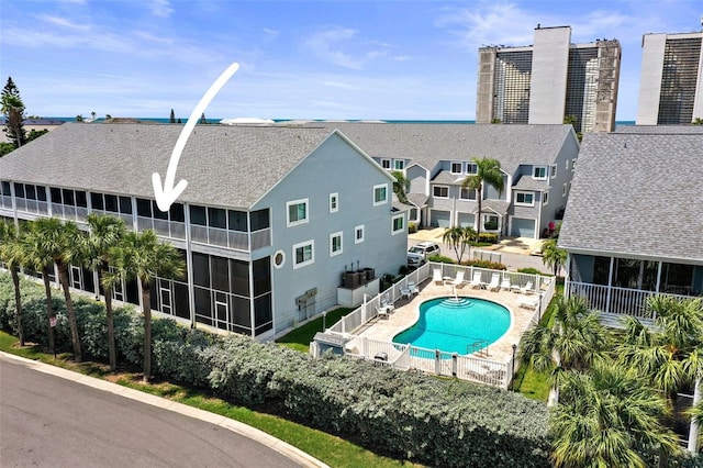 view of swimming pool with a sunroom