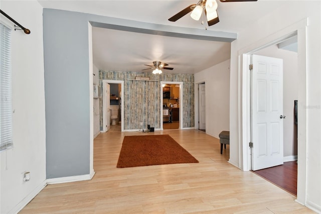 interior space with ceiling fan and light hardwood / wood-style floors