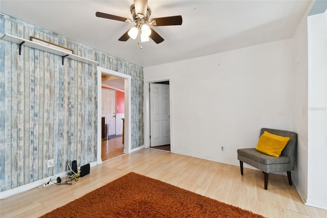 sitting room with light hardwood / wood-style flooring and ceiling fan