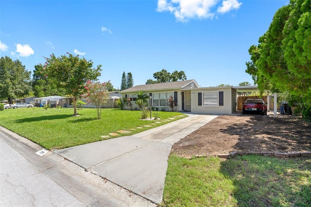 single story home with driveway, a carport, a front yard, and fence