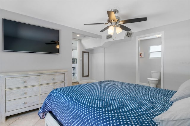 bedroom featuring ceiling fan, light tile patterned flooring, and connected bathroom