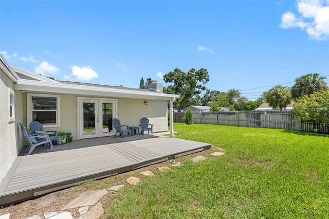 view of yard with a deck and french doors