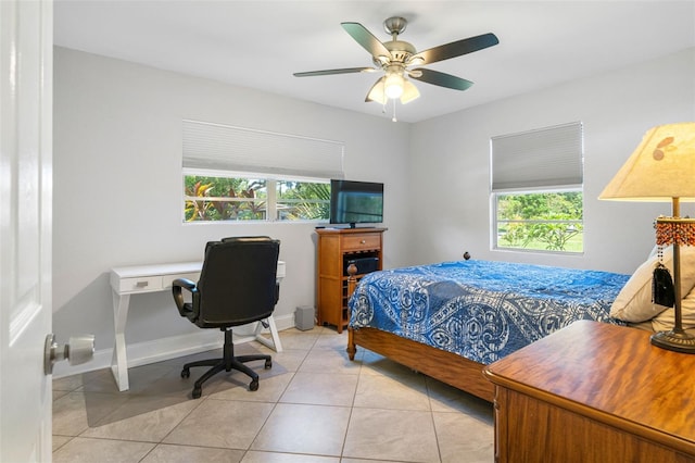 bedroom with multiple windows, light tile patterned floors, and ceiling fan