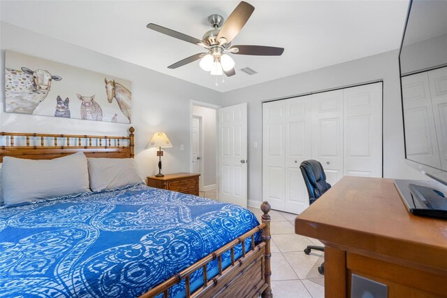 tiled bedroom featuring ceiling fan