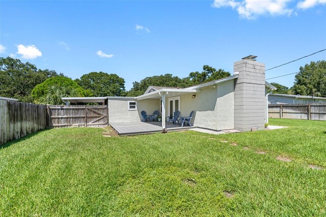 rear view of property with a yard