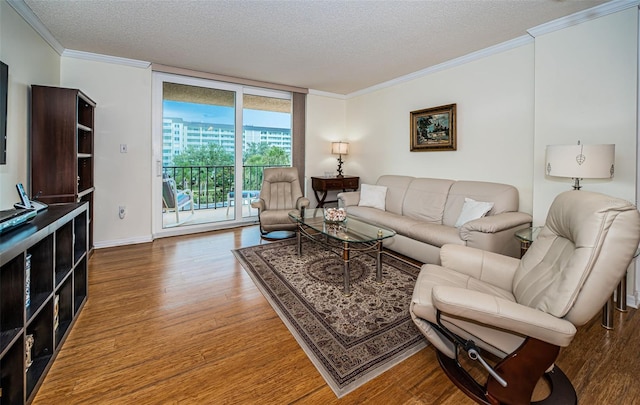 living room with ornamental molding, a textured ceiling, and hardwood / wood-style floors