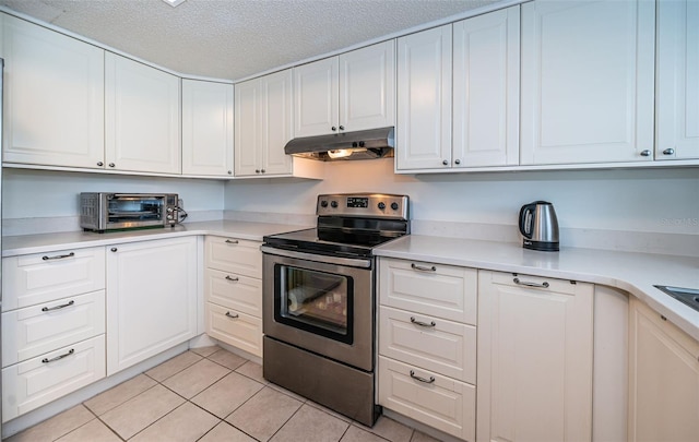 kitchen featuring light tile patterned floors, electric stove, white cabinetry, and a textured ceiling