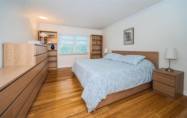 bedroom with light hardwood / wood-style flooring and ornamental molding