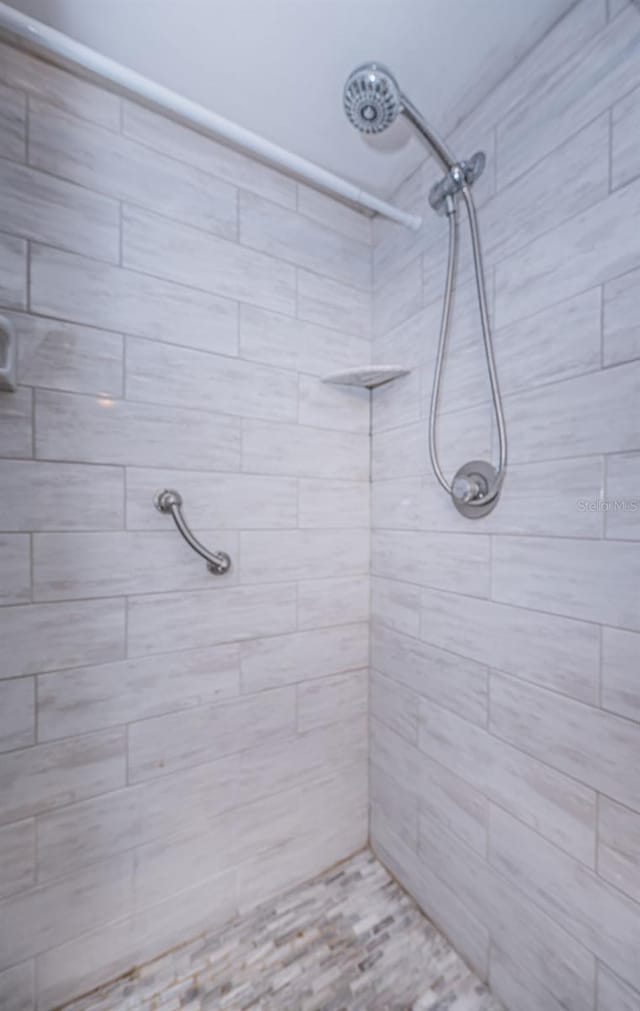 bathroom with a tile shower