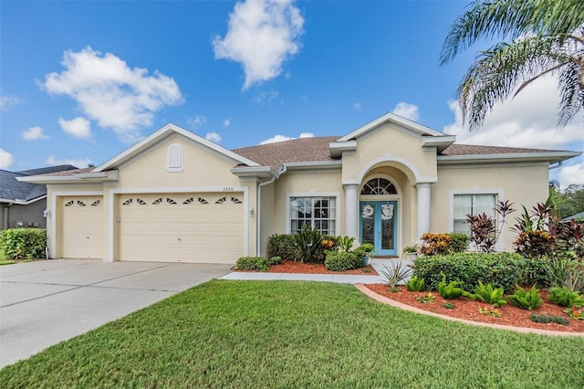 ranch-style house featuring an attached garage, concrete driveway, french doors, stucco siding, and a front lawn