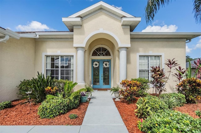 property entrance with french doors and stucco siding