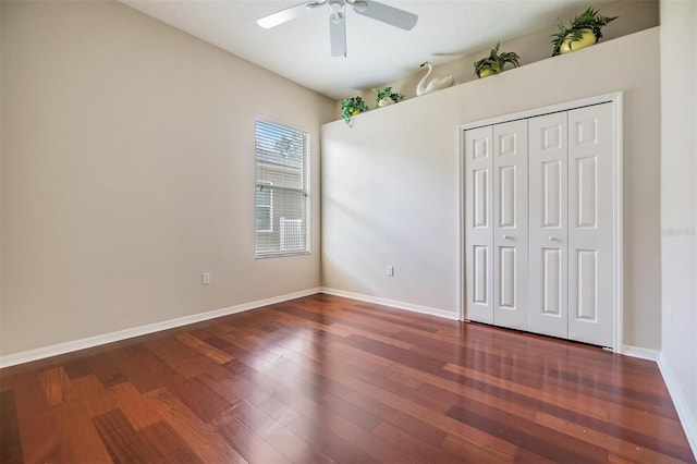 unfurnished bedroom featuring a closet, ceiling fan, baseboards, and wood finished floors