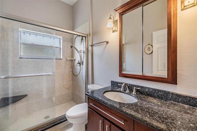 bathroom with vanity, toilet, and an enclosed shower