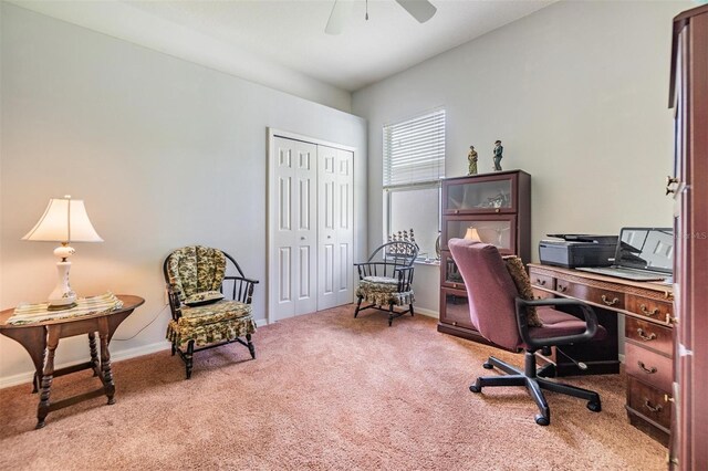 carpeted office space featuring ceiling fan