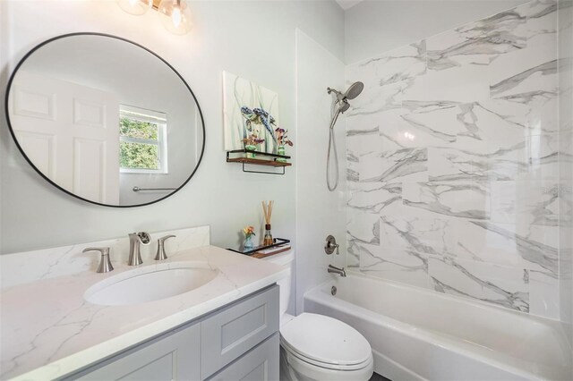 full bathroom with vanity, toilet, and tiled shower / bath