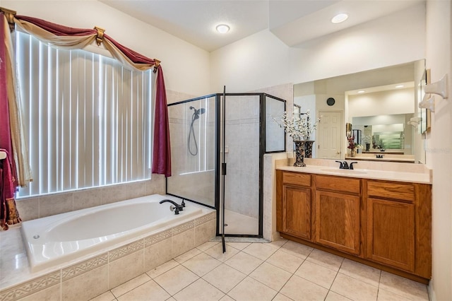 bathroom featuring vanity, independent shower and bath, and tile patterned floors