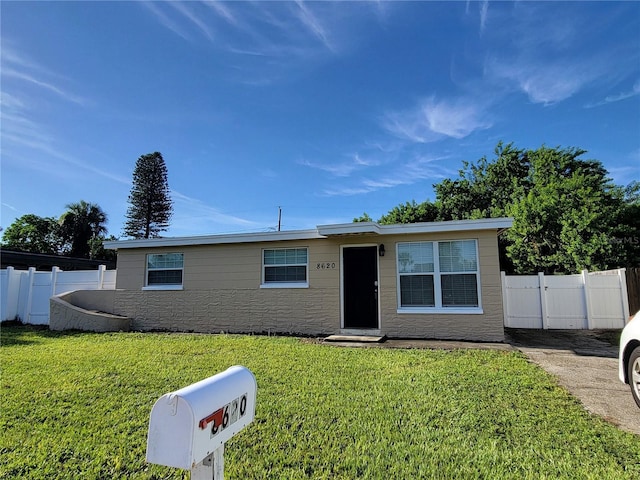 view of front of house featuring a front yard and fence