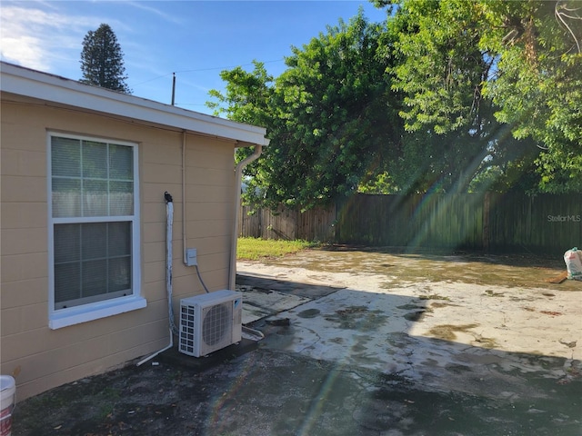 view of yard featuring ac unit, fence, and a patio