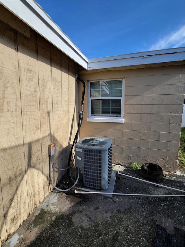 details featuring cooling unit and concrete block siding