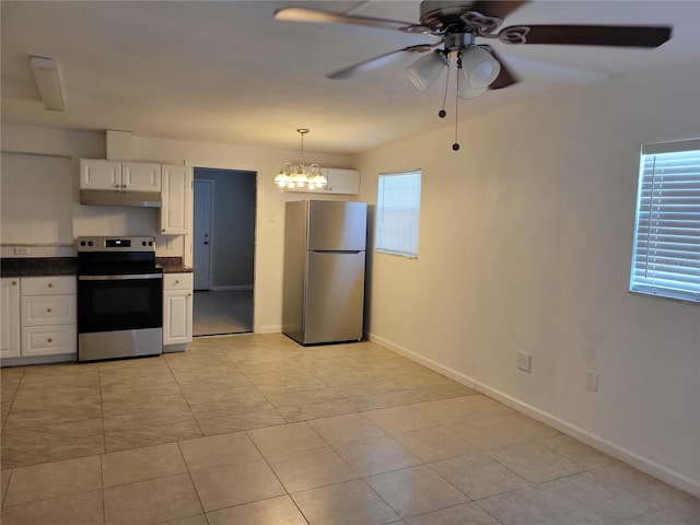 kitchen featuring pendant lighting, stainless steel appliances, dark countertops, white cabinetry, and under cabinet range hood