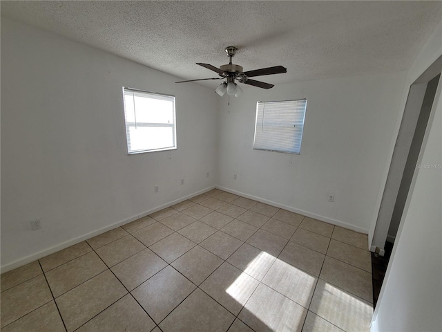 unfurnished room featuring ceiling fan, a textured ceiling, and light tile patterned floors