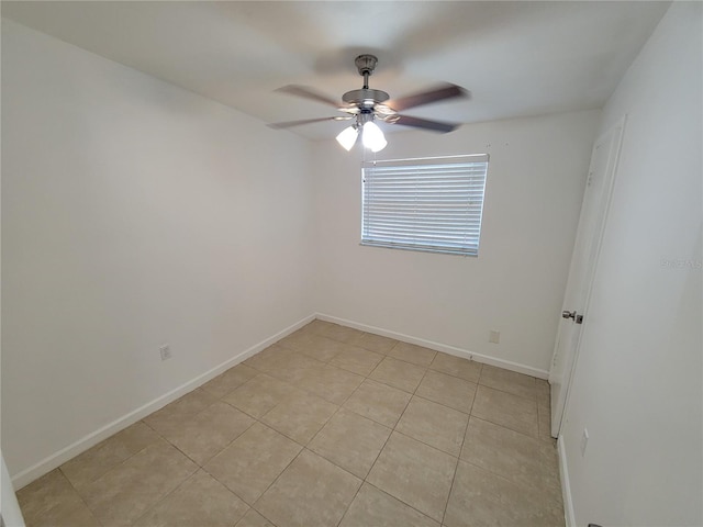 unfurnished room with ceiling fan, baseboards, and light tile patterned flooring