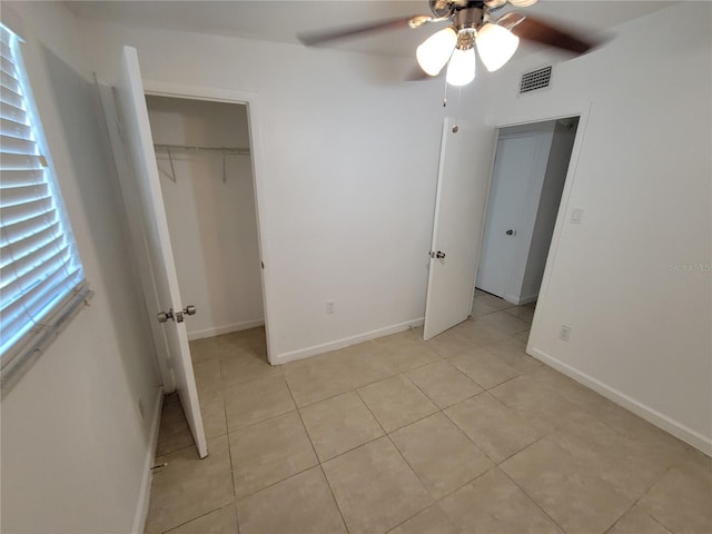 unfurnished bedroom featuring ceiling fan, a closet, visible vents, and baseboards