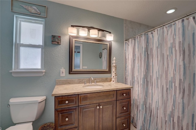 bathroom featuring a shower with curtain, vanity, and toilet