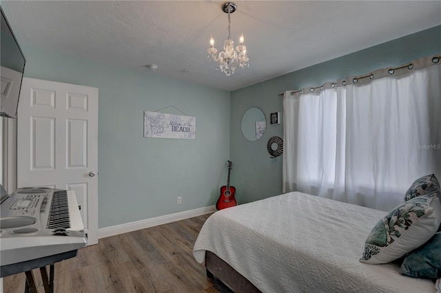 bedroom with a chandelier and hardwood / wood-style flooring