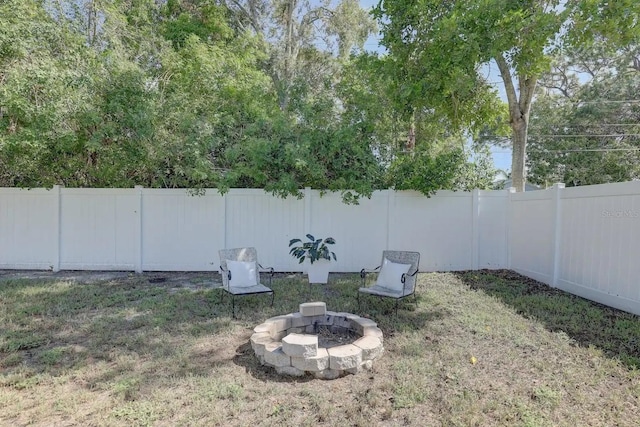 view of yard with an outdoor fire pit