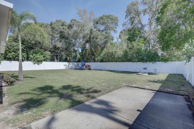 view of yard featuring a playground and a patio