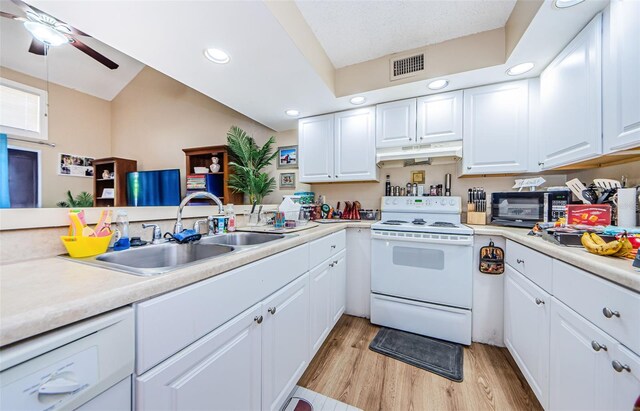 kitchen with sink, light wood-type flooring, white cabinets, ceiling fan, and white electric range